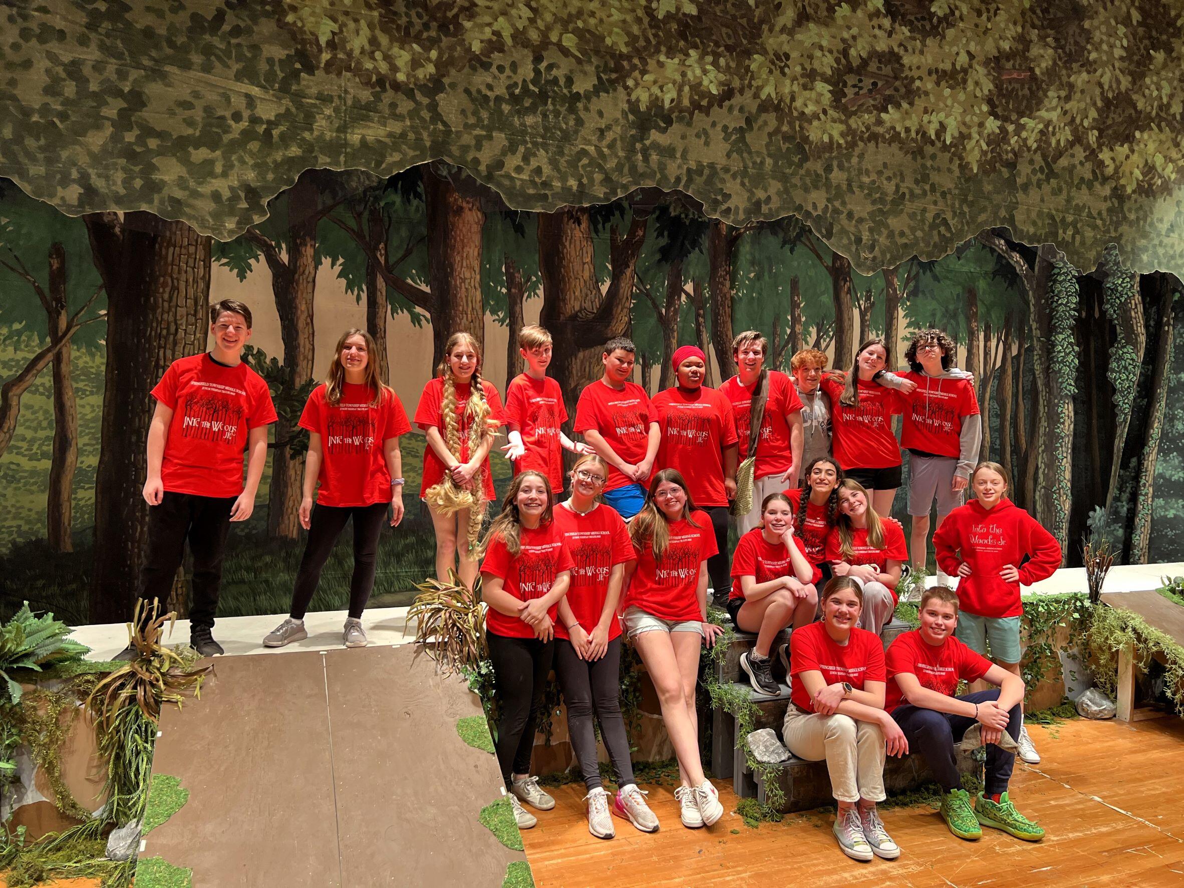 MS- Cast of Into the Woods, all wearing red shirts. The shirts say, Into the Woods.