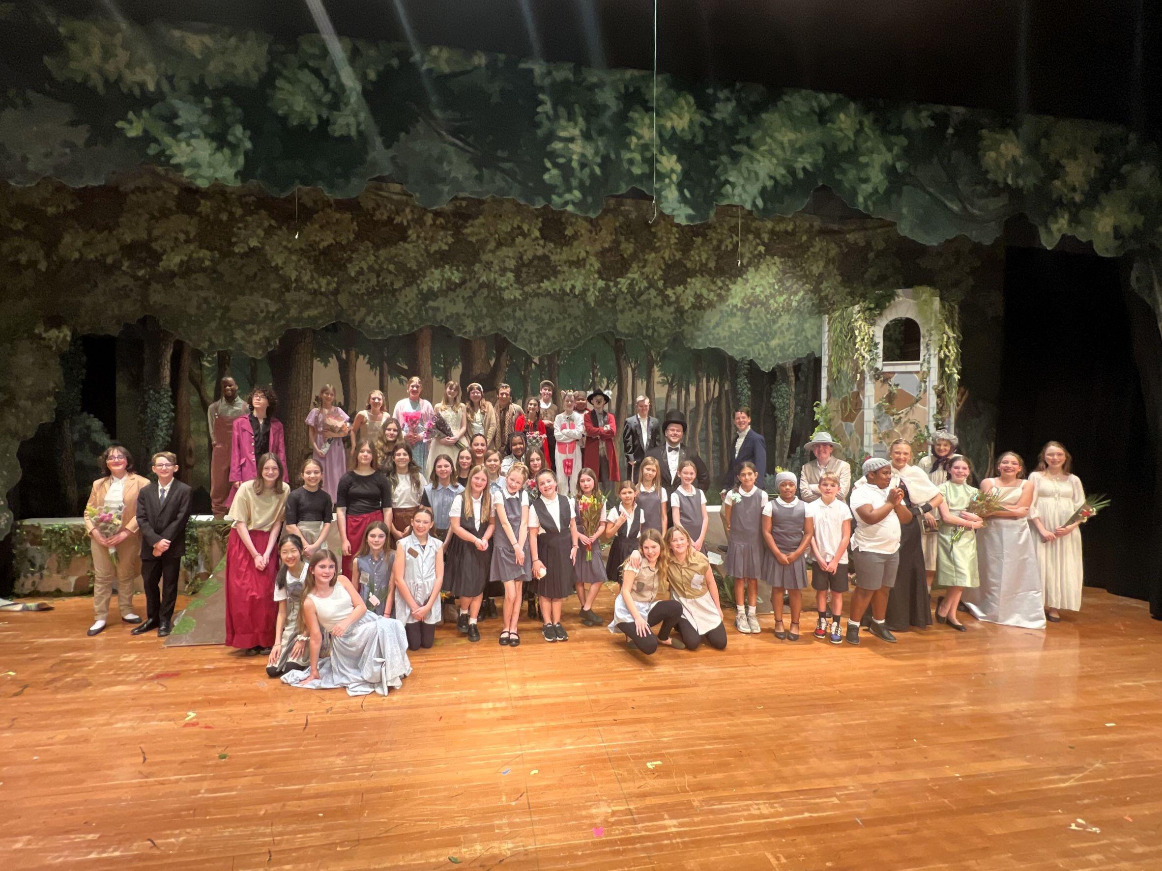 entire cast of Into the Woods posing for a group photo